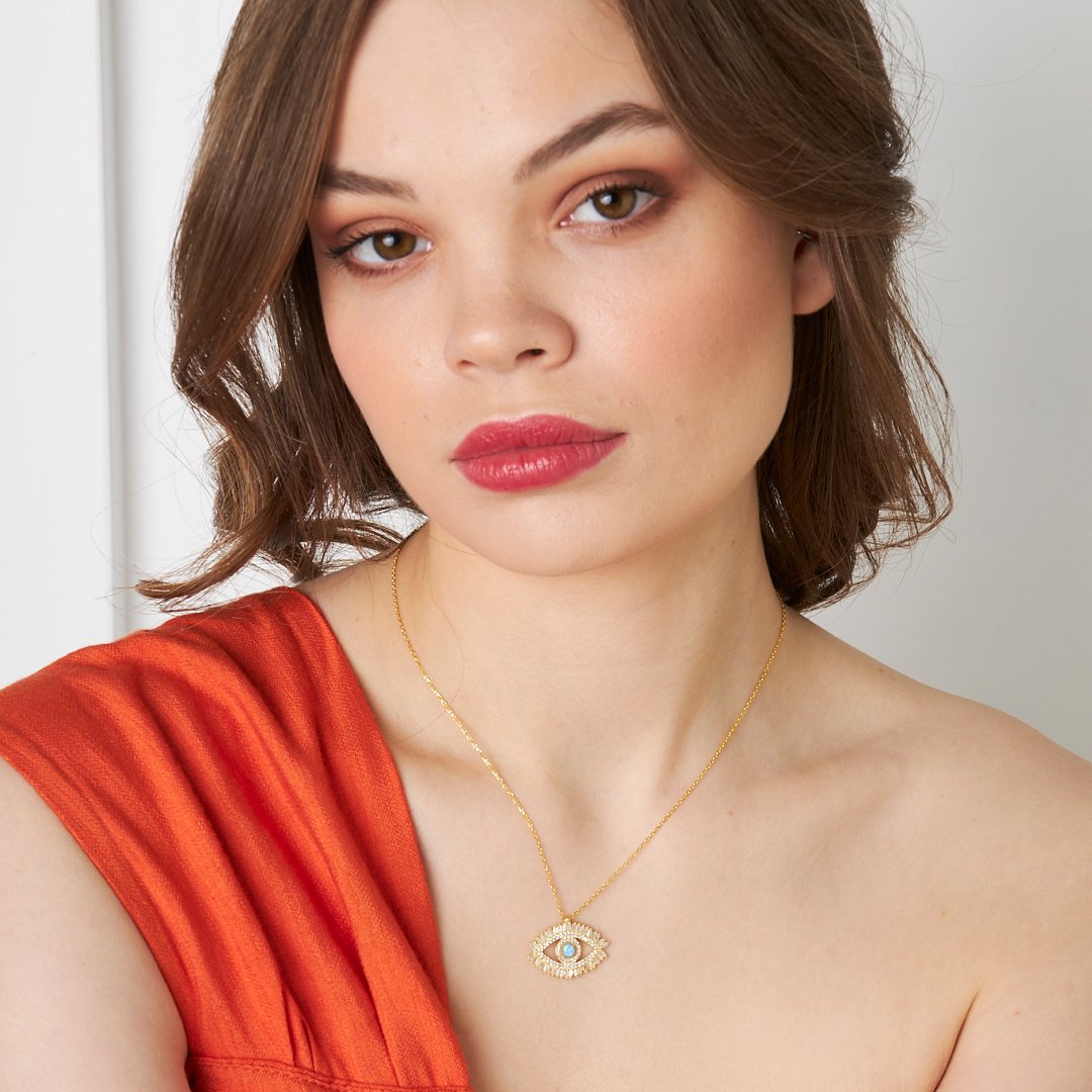 14K gold eye necklace worn by a model, showcasing baguette stones, elegant and stylish jewelry design.