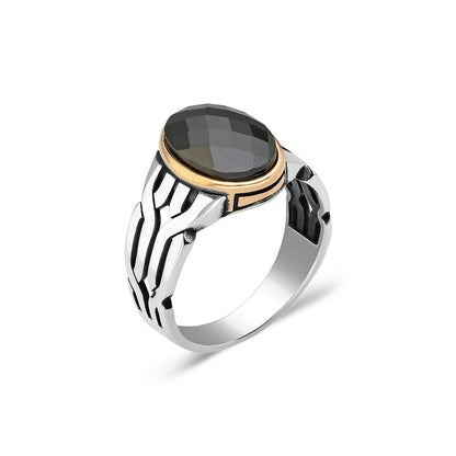 Ring with braid pattern and black stones