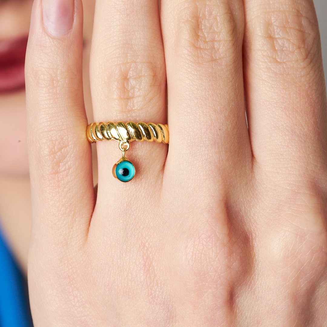 ring with dangling evil eye